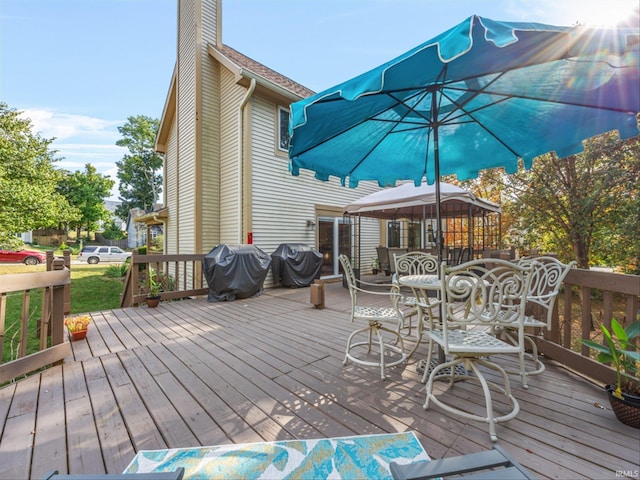 wooden deck with a grill