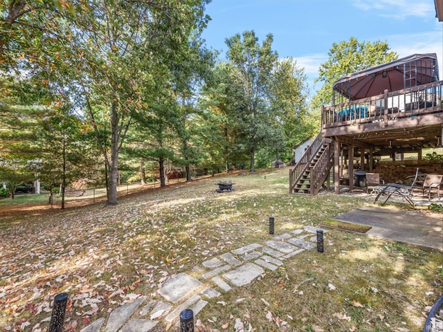 view of yard with an outdoor fire pit, a patio, and a deck