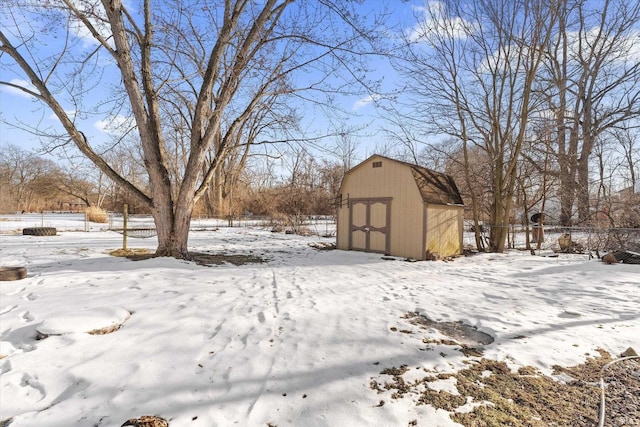 snowy yard with a storage unit