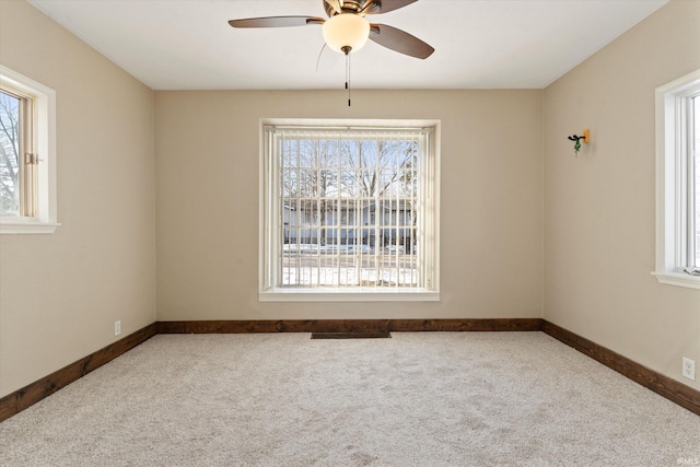 unfurnished room with ceiling fan, plenty of natural light, and carpet floors