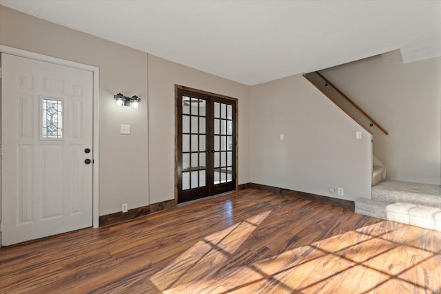 entrance foyer featuring dark hardwood / wood-style floors and french doors