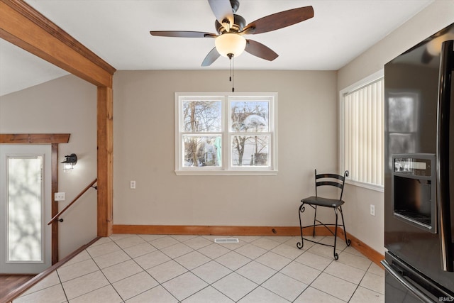 interior space with light tile patterned floors, vaulted ceiling, and ceiling fan