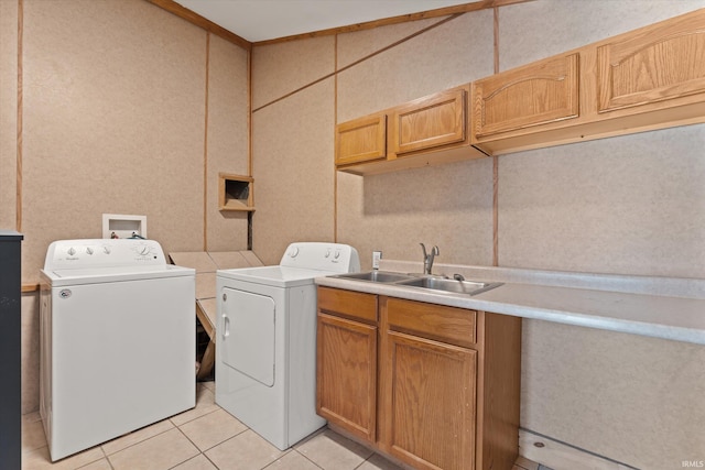 laundry area with separate washer and dryer, sink, and light tile patterned floors