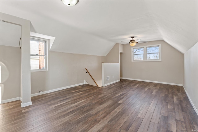 additional living space featuring dark hardwood / wood-style flooring, plenty of natural light, and lofted ceiling