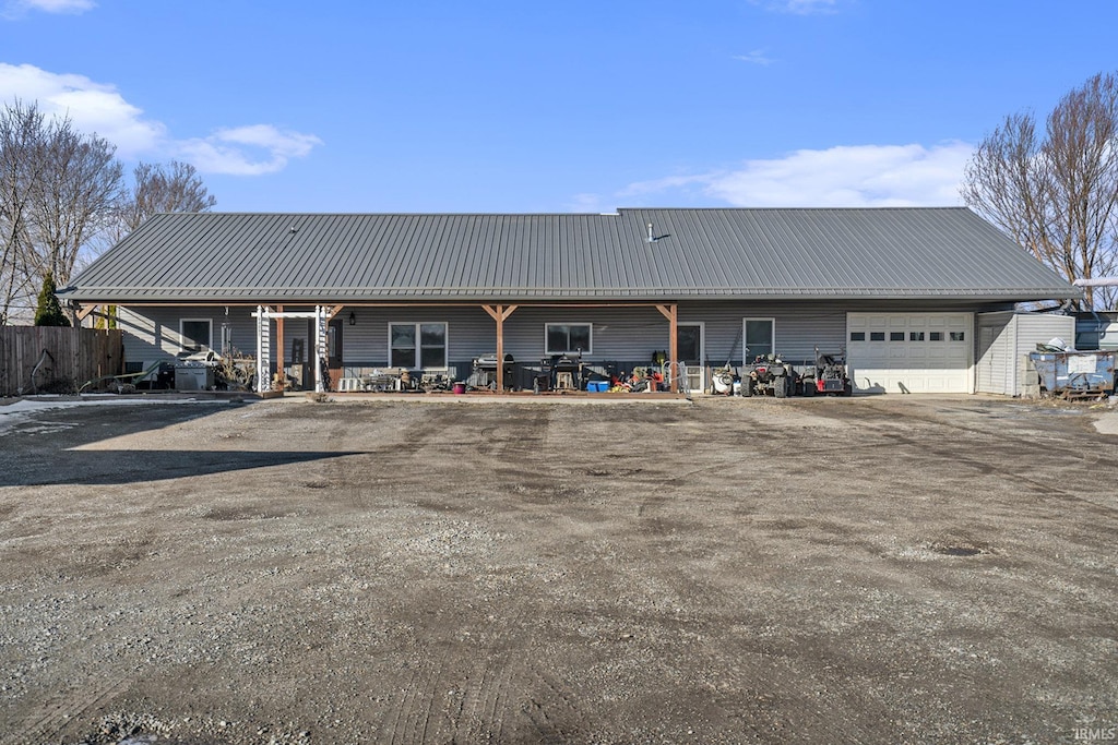 back of property featuring a garage