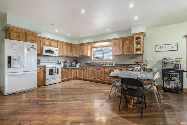 kitchen with dark hardwood / wood-style floors and white appliances