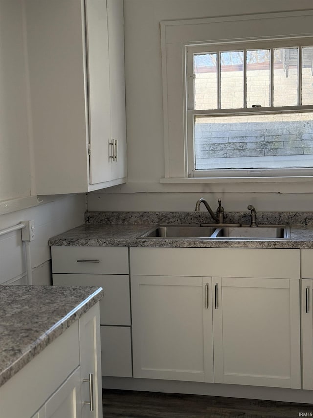 kitchen featuring sink and white cabinets