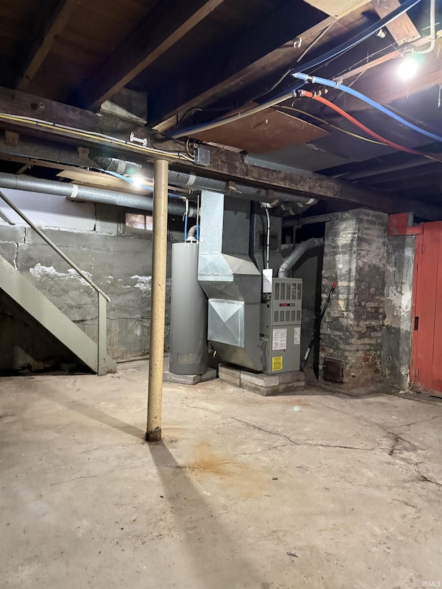 basement featuring water heater and heating unit