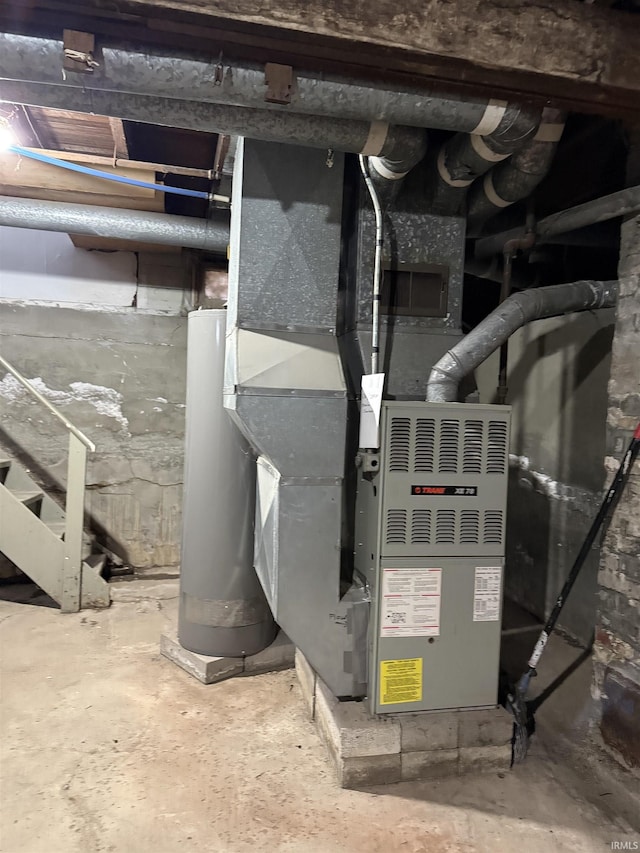 utility room featuring gas water heater