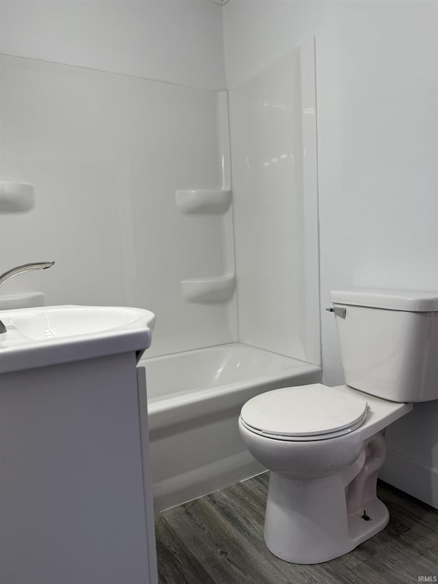 full bathroom with vanity, wood-type flooring, bathtub / shower combination, and toilet