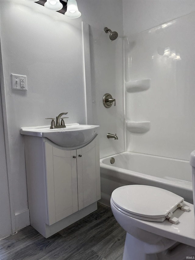 full bathroom featuring vanity, wood-type flooring, toilet, and washtub / shower combination