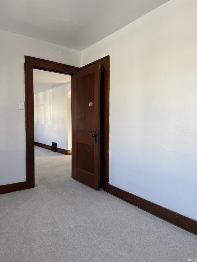 empty room with light colored carpet