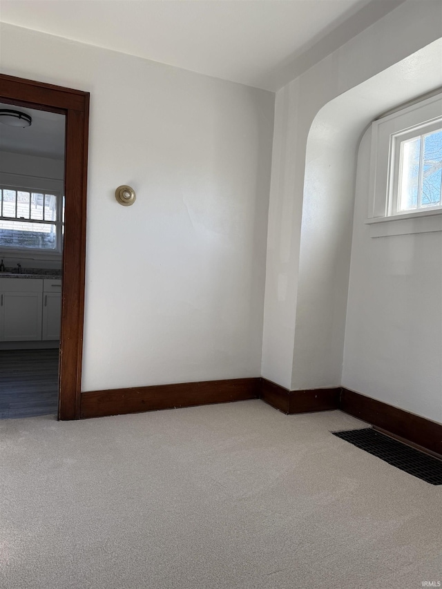 empty room with sink and carpet