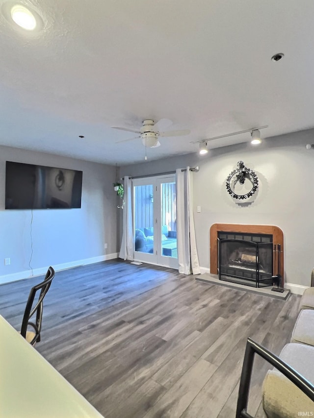 living room with hardwood / wood-style floors, rail lighting, and ceiling fan