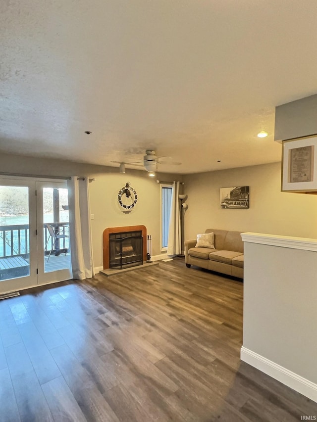 unfurnished living room featuring hardwood / wood-style floors and ceiling fan