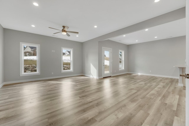 unfurnished living room with light hardwood / wood-style floors and ceiling fan