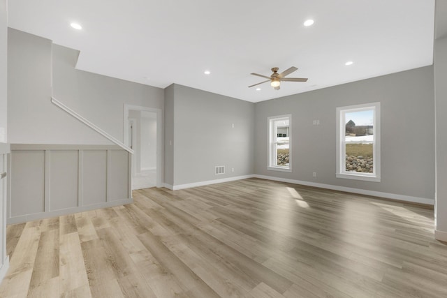 unfurnished living room featuring light hardwood / wood-style floors and ceiling fan