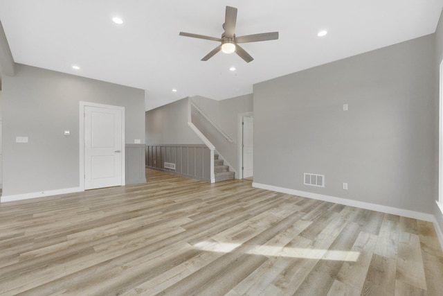 unfurnished living room with ceiling fan and light hardwood / wood-style flooring