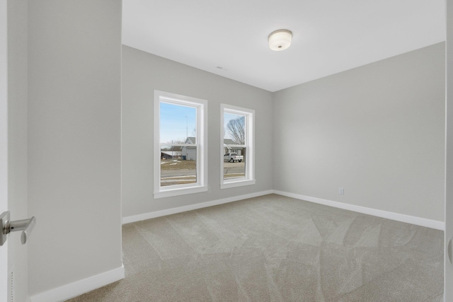 spare room featuring light colored carpet