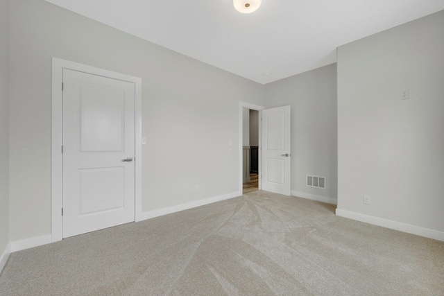 unfurnished bedroom featuring light carpet