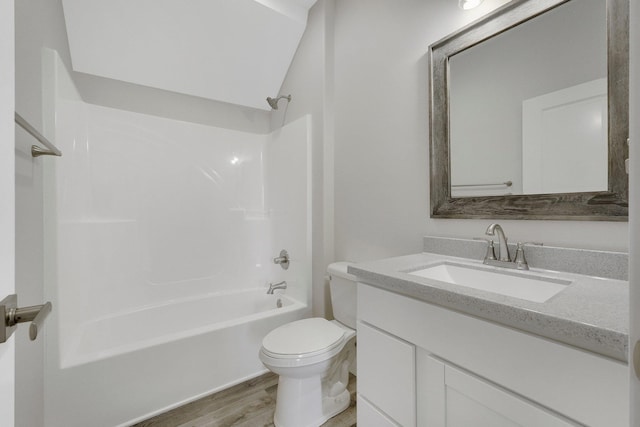 full bathroom featuring vanity, hardwood / wood-style floors,  shower combination, and toilet