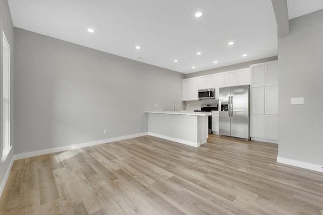 unfurnished living room with sink and light wood-type flooring