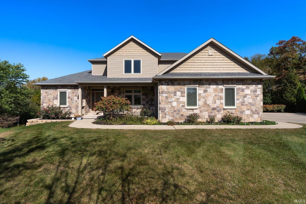 craftsman-style home featuring a porch and a front lawn