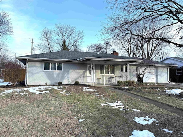 ranch-style house with a garage, a lawn, and covered porch