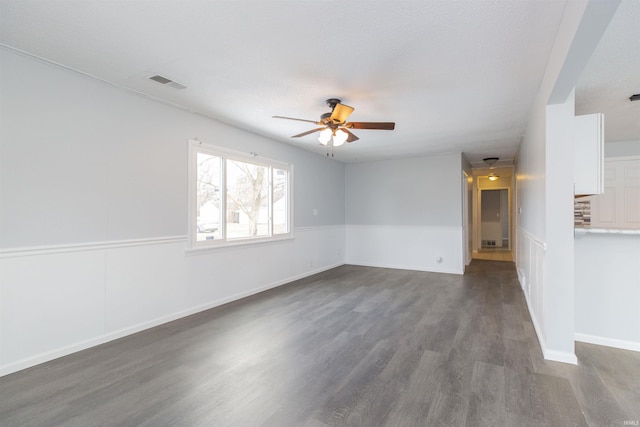 unfurnished room with ceiling fan and dark hardwood / wood-style flooring