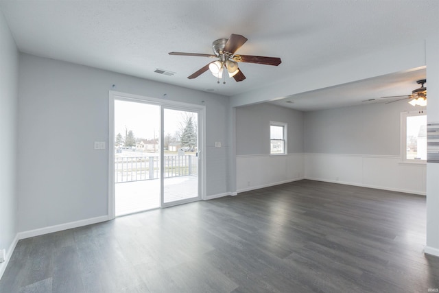 unfurnished room featuring ceiling fan, dark hardwood / wood-style flooring, and a textured ceiling