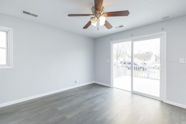 unfurnished room with ceiling fan and dark hardwood / wood-style flooring