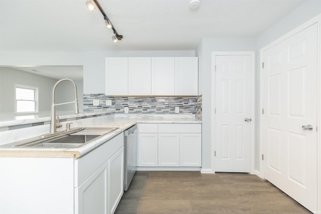 kitchen with dishwasher, white cabinetry, sink, decorative backsplash, and hardwood / wood-style flooring