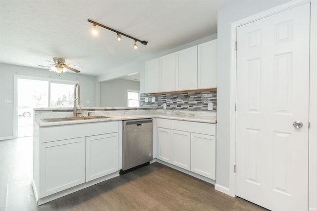 kitchen featuring sink, dark wood-type flooring, dishwasher, white cabinetry, and decorative backsplash