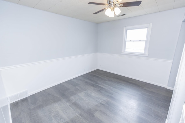 spare room featuring ceiling fan and dark hardwood / wood-style flooring