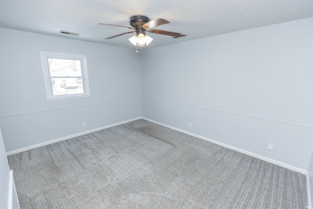 unfurnished room with ceiling fan, carpet floors, and a textured ceiling