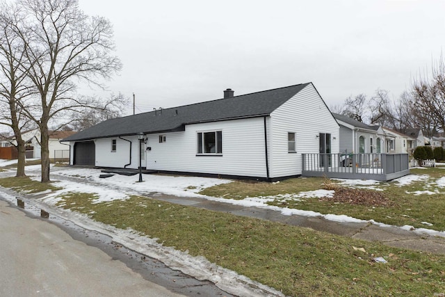 view of front of house featuring a garage and a deck