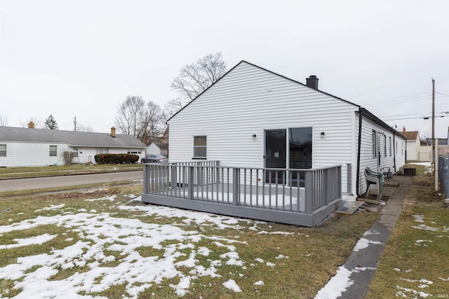 snow covered property with a deck