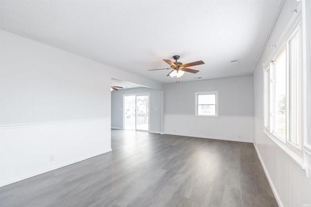 unfurnished room featuring dark wood-type flooring and ceiling fan