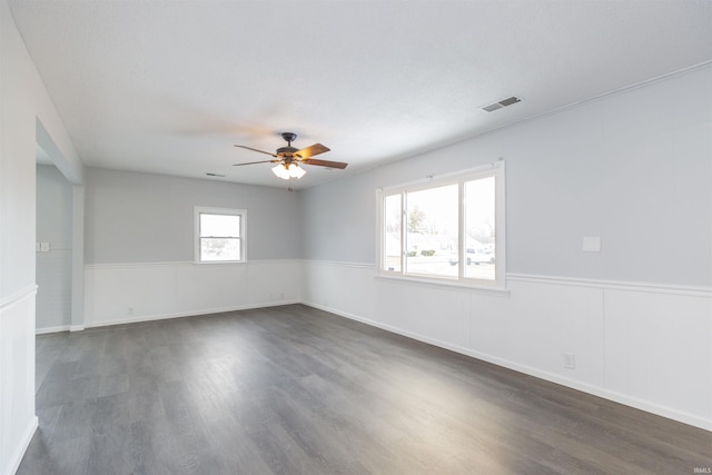 unfurnished room with dark hardwood / wood-style floors and ceiling fan