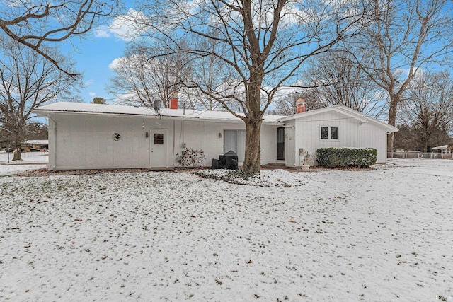 view of snow covered rear of property