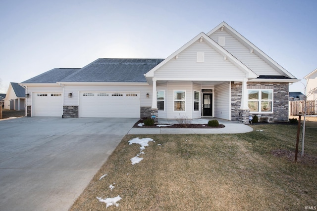 craftsman-style home featuring a garage and a front lawn