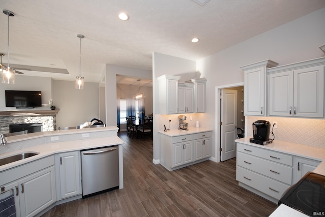 kitchen featuring sink, decorative light fixtures, stainless steel dishwasher, and white cabinets