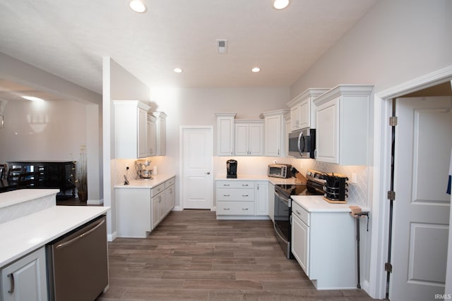 kitchen featuring white cabinetry, decorative backsplash, and stainless steel appliances