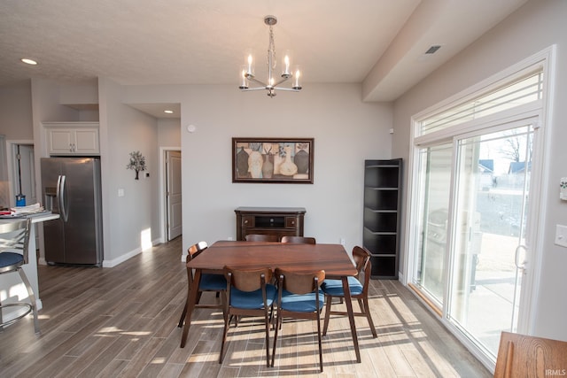 dining room with an inviting chandelier and dark hardwood / wood-style floors