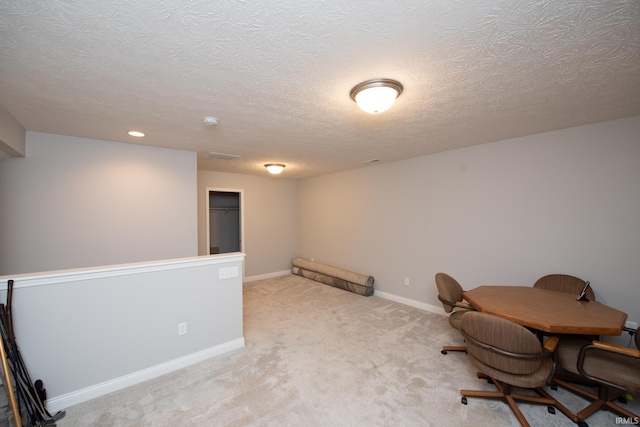 carpeted office space with a textured ceiling