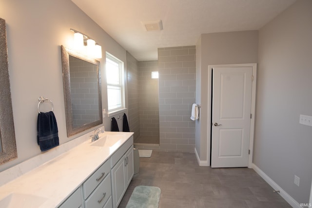 bathroom featuring vanity and a tile shower