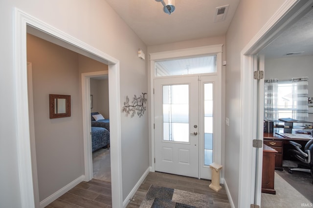 foyer with dark hardwood / wood-style flooring