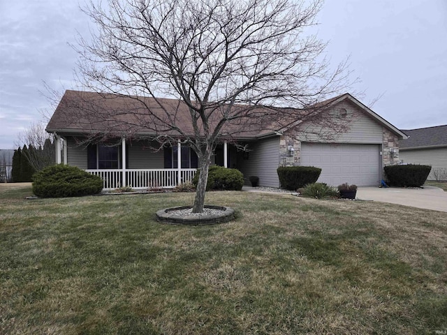 ranch-style home featuring a garage, a front yard, and covered porch