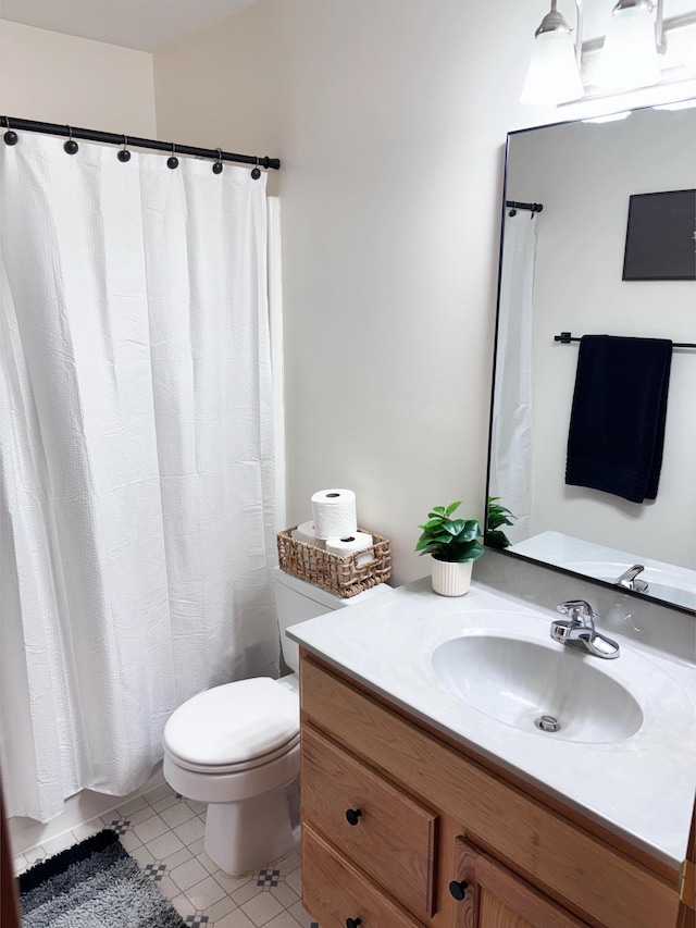 bathroom featuring vanity, a shower with curtain, tile patterned floors, and toilet