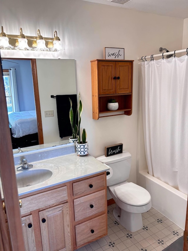 full bathroom featuring tile patterned floors, vanity, toilet, and shower / tub combo